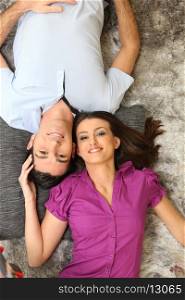 Couple laying on rug
