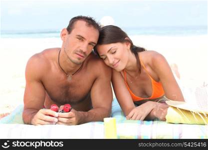 Couple laying on towel at the beach