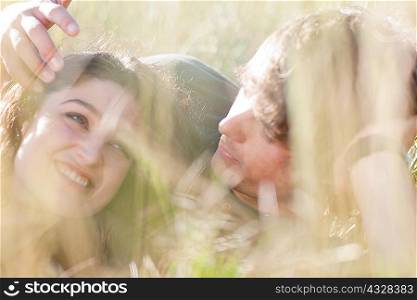 Couple laying together in tall grass