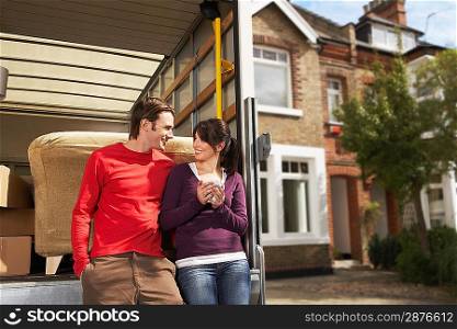 Couple Leaning On Back of Removals Van