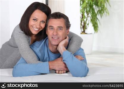 Couple leaning on bed