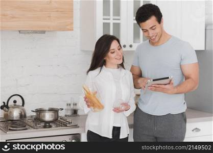 couple learning how cook from online courses