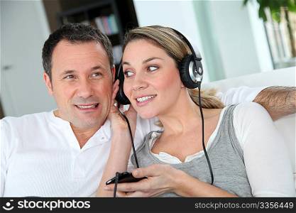 Couple listening to music with headphones