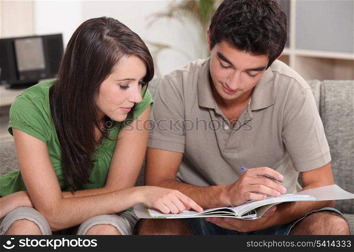 Couple looking at a file at home