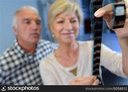 couple looking at a film of different pictures