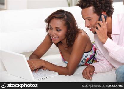Couple looking at a laptop on a sofa