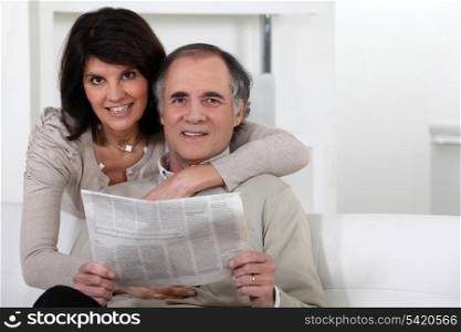 Couple looking at a newspaper