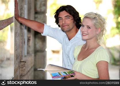 Couple looking at a tourist information board