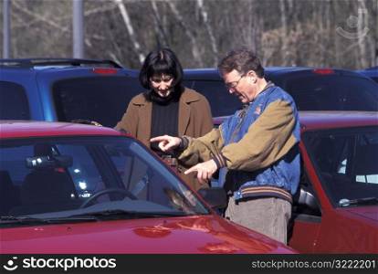 Couple Looking at Cars
