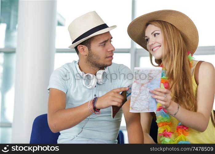 couple looking at map in the airport