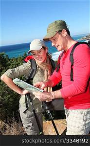 Couple looking at map on a hiking day