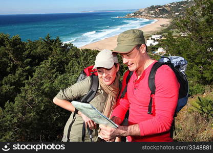 Couple looking at map on a hiking day