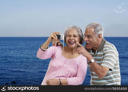 Couple looking at photographs in a camera