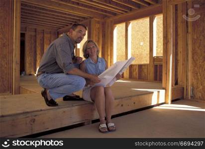 Couple Looking At Plans
