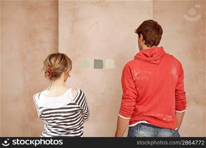 Couple Looking at Sample Paint Colors on Wall