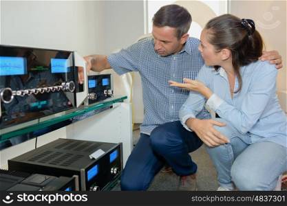 Couple looking at sound systems