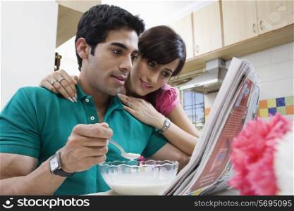 Couple looking at the morning newspaper