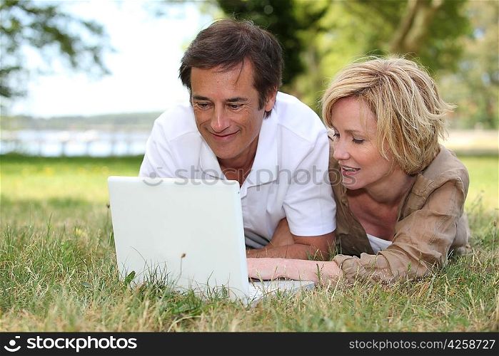 Couple looking at their laptop