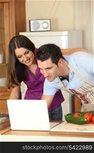 Couple looking for a recipe on the internet