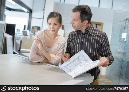 couple looking for plans of new house