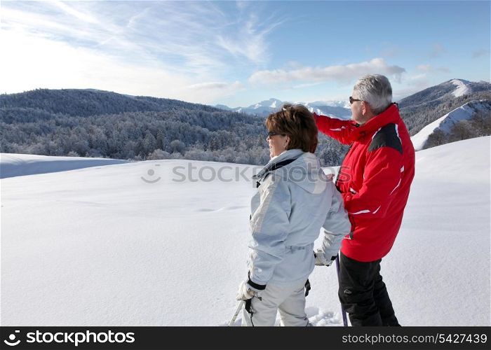 Couple looking landscape in the snow