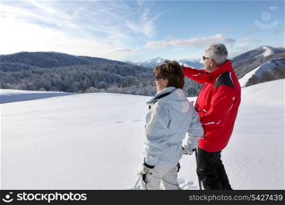 Couple looking landscape in the snow