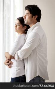 Couple looking out of window