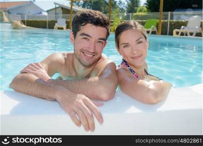 Couple looking over side of pool