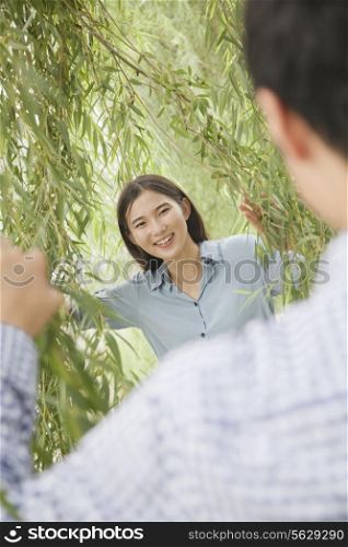 Couple Looking Through Willow Branches