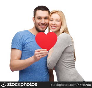 couple, love and family concept - smiling couple holding big red heart