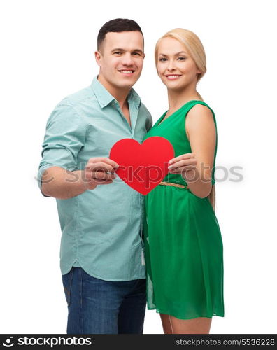 couple, love and family concept - smiling couple holding big red heart