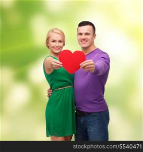 couple, love and family concept - smiling couple holding big red heart