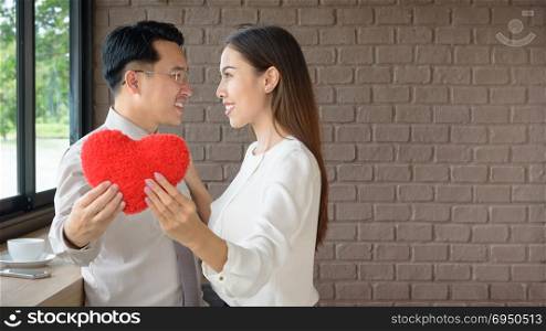 couple love man and woman holding red heart, love and valentine concept