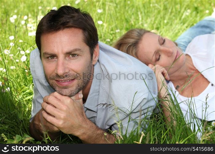 Couple lying amongst the daisies