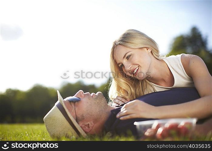 Couple lying and chatting in park