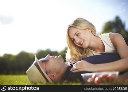 Couple lying and chatting in park