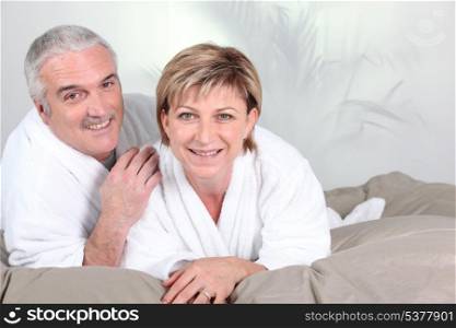 Couple lying in bed after a shower