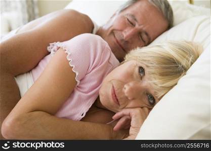 Couple lying in bed together
