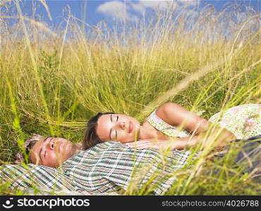 couple lying in field of high grasses