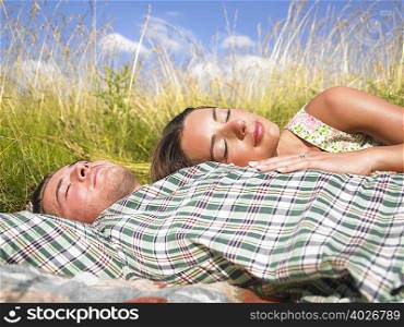 couple lying in field of high grasses