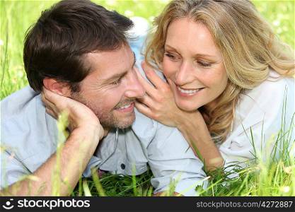 Couple lying in grass