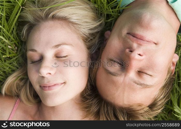 Couple lying in grass sleeping