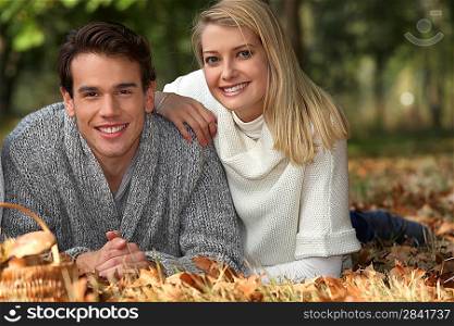 Couple lying in the leaves