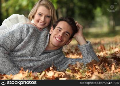 Couple lying in the leaves
