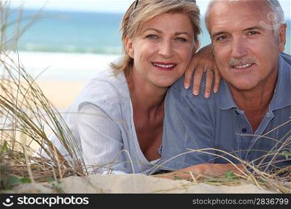 couple lying in the sand dunes