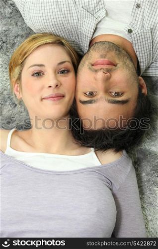 Couple lying on a carpet