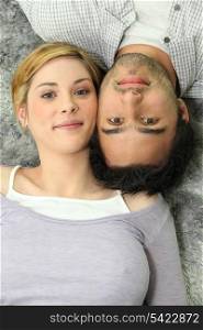 Couple lying on a carpet