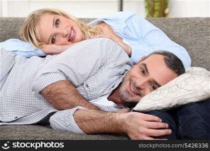 Couple lying on a sofa