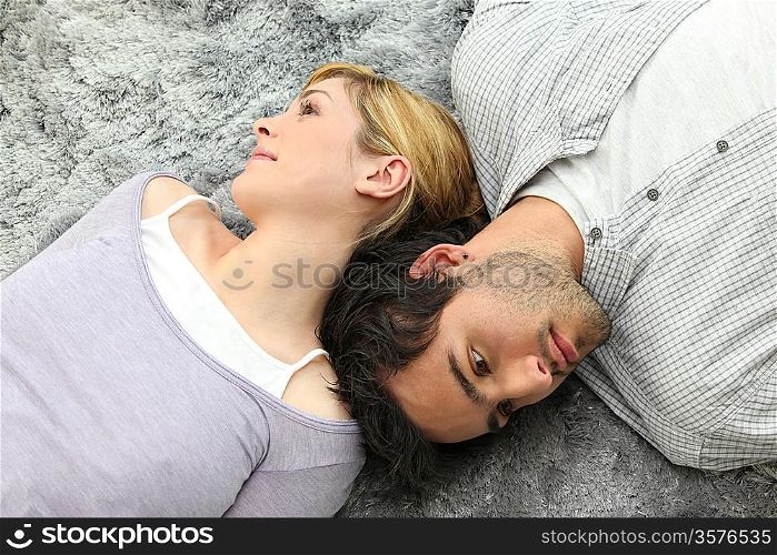 Couple lying on carpet