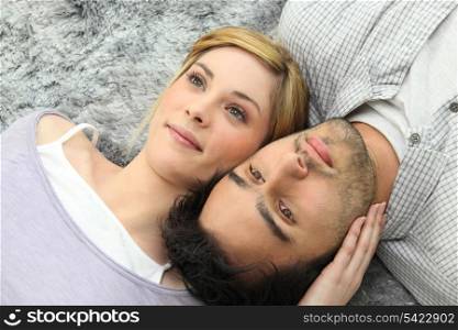 Couple lying on carpet
